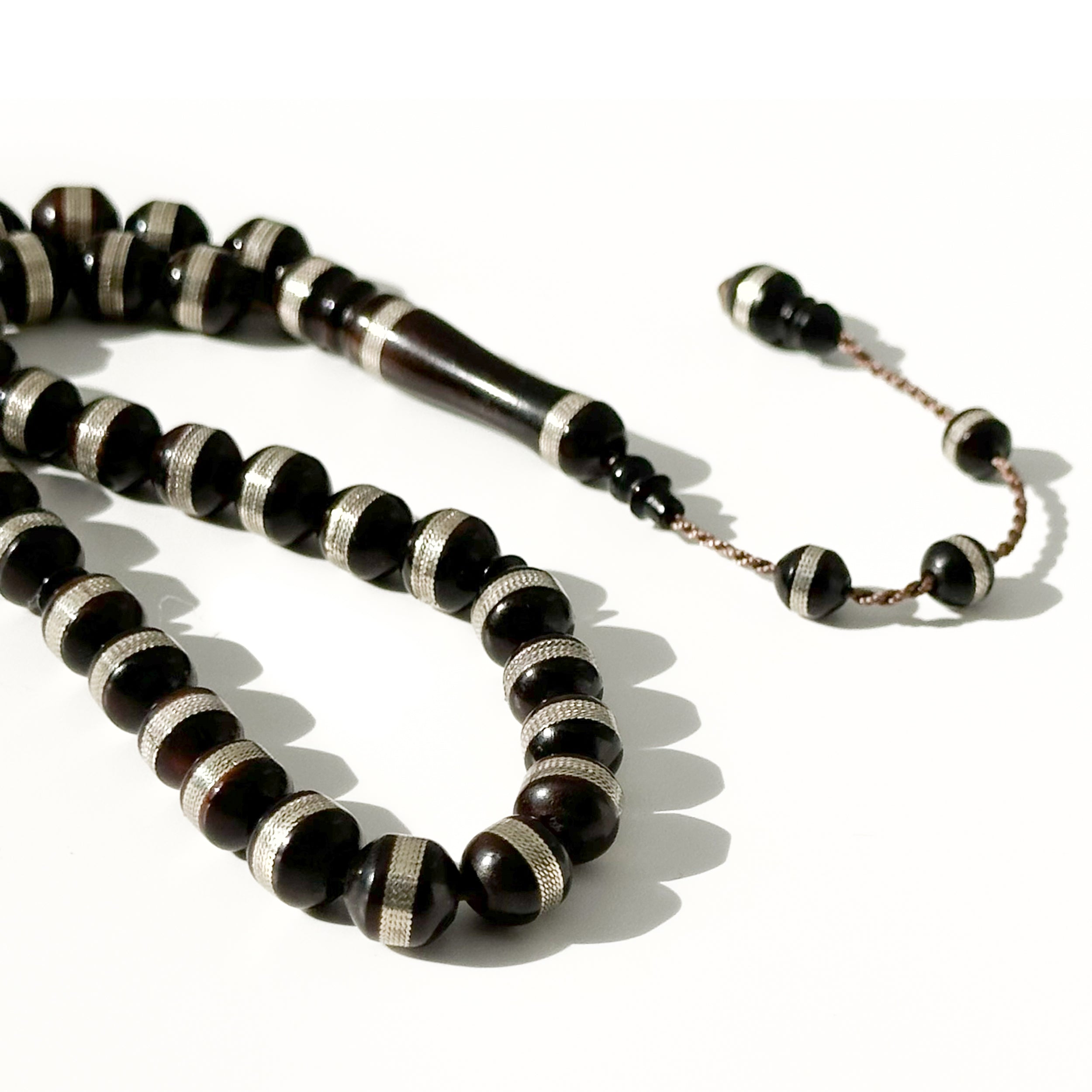 Black Kawk, adorned with metal and stones, 10 mm, 33 beads